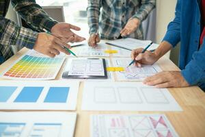 The designer team is designing the uxui system to make the uxui system work well on new phones and support system updates. Website development concept UI UX front end designer photo