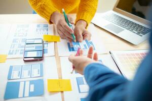 The designer team is designing the uxui system to make the uxui system work well on new phones and support system updates. Website development concept UI UX front end designer photo