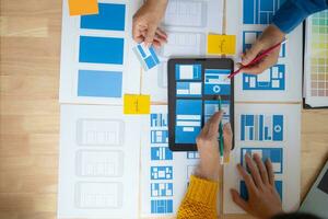 The designer team is designing the uxui system to make the uxui system work well on new phones and support system updates. Website development concept UI UX front end designer photo