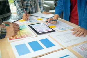 The designer team is designing the uxui system to make the uxui system work well on new phones and support system updates. Website development concept UI UX front end designer photo