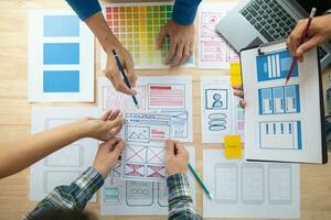 The designer team is designing the uxui system to make the uxui system work well on new phones and support system updates. Website development concept UI UX front end designer photo