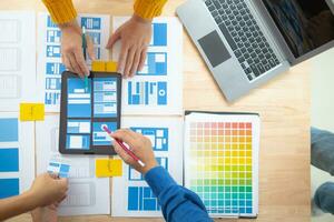 The designer team is designing the uxui system to make the uxui system work well on new phones and support system updates. Website development concept UI UX front end designer photo