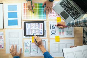 The designer team is designing the uxui system to make the uxui system work well on new phones and support system updates. Website development concept UI UX front end designer photo