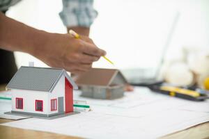 Construction engineers are checking blueprints and calculating their accuracy after receiving plans from architect in order start  construction safely. Inspection Concept from construction engineering photo