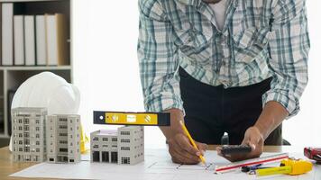 Construction engineers are checking blueprints and calculating their accuracy after receiving plans from architect in order start  construction safely. Inspection Concept from construction engineering photo