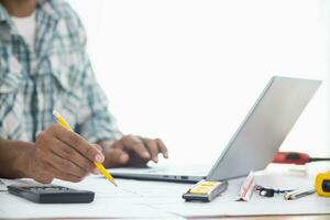 Construction engineers are checking blueprints and calculating their accuracy after receiving plans from architect in order start  construction safely. Inspection Concept from construction engineering photo