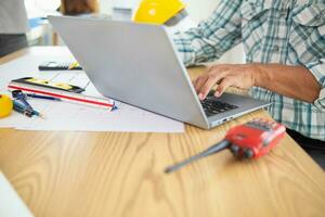 Construction engineers are checking blueprints and calculating their accuracy after receiving plans from architect in order start  construction safely. Inspection Concept from construction engineering photo