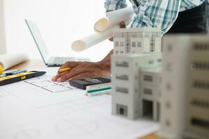 Construction engineers are checking blueprints and calculating their accuracy after receiving plans from architect in order start  construction safely. Inspection Concept from construction engineering photo