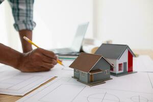 Construction engineers are checking blueprints and calculating their accuracy after receiving plans from architect in order start  construction safely. Inspection Concept from construction engineering photo