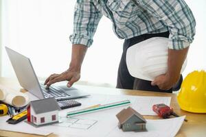Construction engineers are checking blueprints and calculating their accuracy after receiving plans from architect in order start  construction safely. Inspection Concept from construction engineering photo