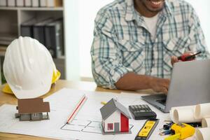 Construction engineers are checking blueprints and calculating their accuracy after receiving plans from architect in order start  construction safely. Inspection Concept from construction engineering photo