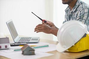 Construction engineers are checking blueprints and calculating their accuracy after receiving plans from architect in order start  construction safely. Inspection Concept from construction engineering photo
