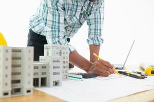 Construction engineers are checking blueprints and calculating their accuracy after receiving plans from architect in order start  construction safely. Inspection Concept from construction engineering photo