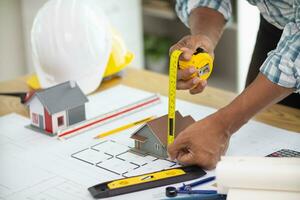 Construction engineers are checking blueprints and calculating their accuracy after receiving plans from architect in order start  construction safely. Inspection Concept from construction engineering photo
