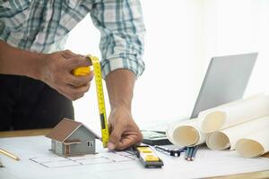 Construction engineers are checking blueprints and calculating their accuracy after receiving plans from architect in order start  construction safely. Inspection Concept from construction engineering photo
