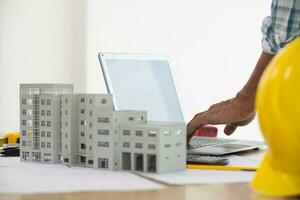 Construction engineers are checking blueprints and calculating their accuracy after receiving plans from architect in order start  construction safely. Inspection Concept from construction engineering photo