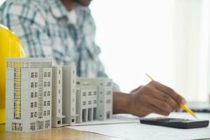 Construction engineers are checking blueprints and calculating their accuracy after receiving plans from architect in order start  construction safely. Inspection Concept from construction engineering photo