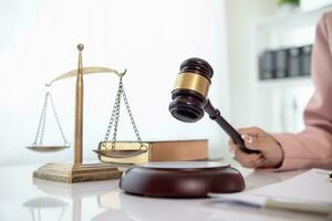 judge's gavel in law office is placed on table to symbolize judge deciding lawsuit. gavel wood on wooden table of lawyers in legal advice office as symbol of fair judgment in cases. photo