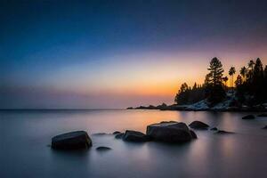 a long exposure photograph of rocks on the shore of a lake. AI-Generated photo