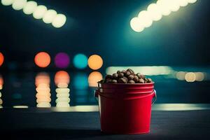 a red bucket filled with peanuts sitting on a table in front of a pool. AI-Generated photo
