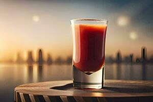 un vaso de rojo líquido sentado en un mesa en frente de un ciudad horizonte. generado por ai foto