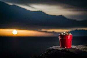 a red bucket with a shell on top of a rock. AI-Generated photo