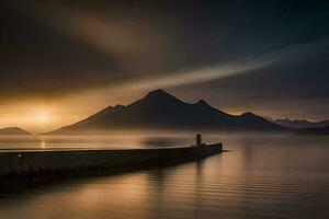 un hombre soportes en un muelle a puesta de sol con montañas en el antecedentes. generado por ai foto