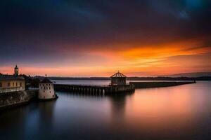 un largo exposición fotografía de un muelle y un Iglesia a puesta de sol. generado por ai foto