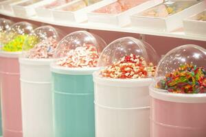 Jelly candies in containers in a store. Large selection of sweets in different colors. Sale of sweets. photo