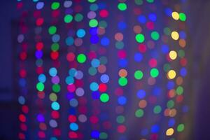 Multicolored bokeh spots on a blue background. Background for the holiday. photo