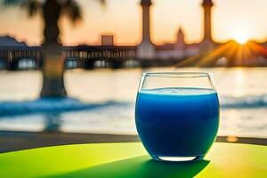 un vaso de azul líquido se sienta en un mesa en frente de el agua. generado por ai foto