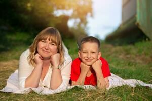 Happy mom and son on a summer walk or picnic smile, spend time together. Mother and son. photo