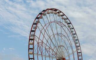 Part of a retro ferris wheel carousel against the sky. photo