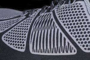 Fragment of black and white cloth sneaker. The texture of the material of sports shoes photo