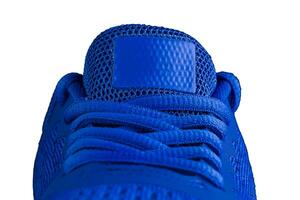 Fragment of a blue sneaker with drawstring macro.Sneaker texture photo