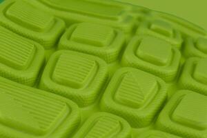 Fragment of a rubber green sole sneaker. Bottom of sports shoes photo