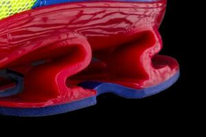 Fragment of the red sneaker sole. The texture of the material of sports shoes photo