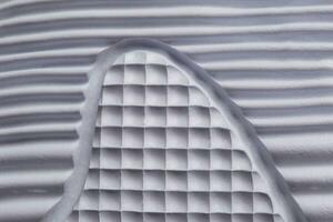 Fragment of a rubber white sole of a sneaker. Bottom of sports shoes photo