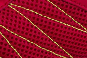 Fragment of red sneaker fabric. The texture of the material of sports shoes photo