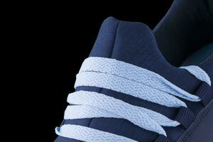 A fragment of a blue sneaker close up. Sneaker texture photo