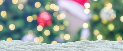 Empty white snow with blur Christmas tree with bokeh light background photo