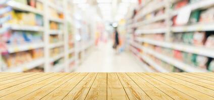 Empty wood table top with supermarket blurred background for product display photo