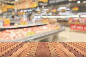 Empty wood table top with supermarket blurred background for product display photo