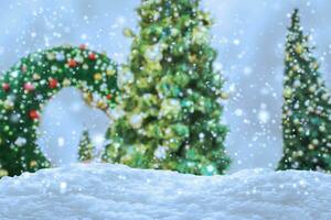 Empty white snow with blur Christmas tree with bokeh light background photo