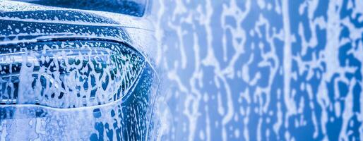 car cleaning and washing with foam soap background photo