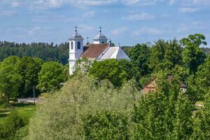 aerial view on neo gothic or baroque temple or catholic church in countryside photo