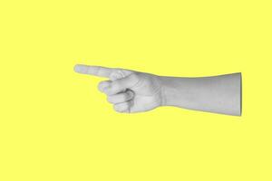 man hand touching or pointing to something isolated on yellow background photo