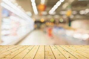 Empty wood table top with supermarket blurred background for product display photo