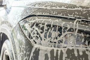 car cleaning and washing with foam soap photo