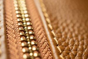 close up of zipper on brown leather bag photo